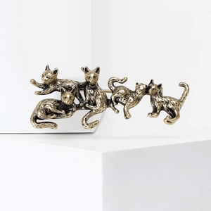 Vintage gold alloy brooch with five playful kittens on a minimalist white stone pedestal