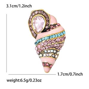 Macro detail of conch brooch showing pink enamel work and crystal inlay measurements