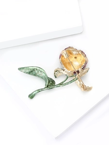 Detail of tulip brooch back showing secure golden pin clasp and enamel leaf texture