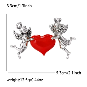 Close-up showing dimensions of vintage cupid angel heart brooch in silver alloy