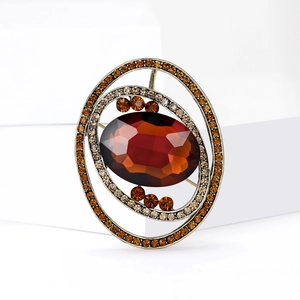 Vintage gold brooch with large red oval gem and sparkling orange rhinestone layers