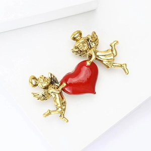 Vintage gold cupid angels brooch with a large glossy red heart enamel design