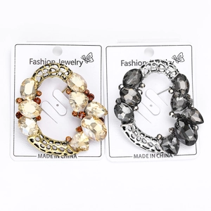 Detailed close-up of retro hollow crystal brooches with geometric patterns and gems