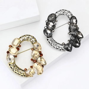 Luxurious vintage hollow crystal brooch in gold and silver finish with sparkling rhinestones