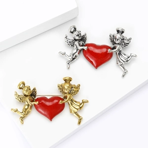 Vintage angel heart brooches in antique silver and gold finish with red enamel wings