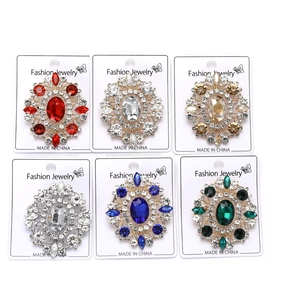 Detailed view of large oval rhinestone brooches in six colors with vintage floral design