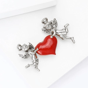 Vintage retro silver angel cupid brooch featuring a large glossy red heart pendant charm