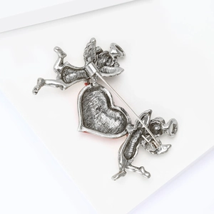 Detailed back view of vintage angel brooch showing the secure metal pin fastening mechanism