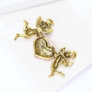 Detailed back view of vintage golden angel heart brooch showing safety pin clasp