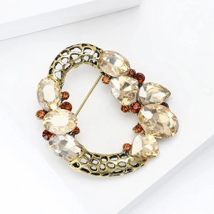 Detailed macro view of vintage gold brooch with champagne crystals and hollow honeycomb texture