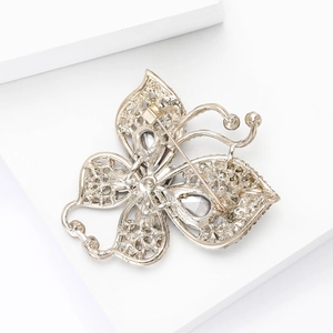 Detail view of the butterfly brooch back with secure safety clasp and gold finish