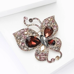 Detailed macro view of luxury hollow butterfly brooch with red crystal teardrops