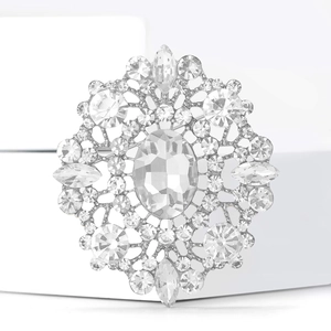Close-up of a large oval crystal brooch with sparkling rhinestones on a silver base