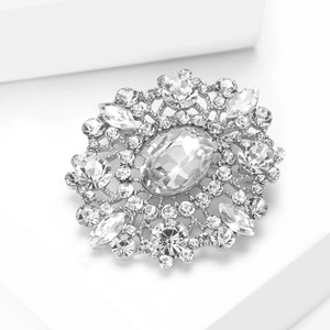 Macro detail of oval crystal brooch with silver vintage sunburst style and brilliant rhinestones