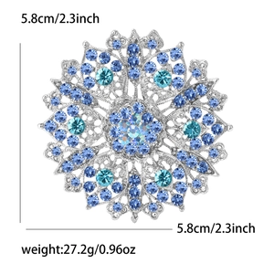 Detailed view of silver snowflake brooch with blue crystals and measurement markers