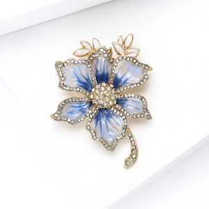 Detail of blue gradient flower brooch with white rhinestones and gold metal base