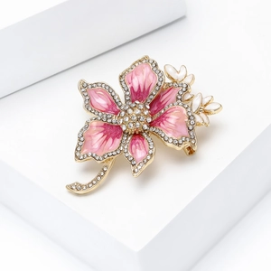 Detail view of flower brooch with pink gradient enamel and sparkling white rhinestones