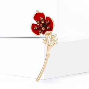 Elegant red poppy flower brooch with gold plating and enamel finish on white pedestal