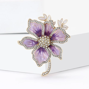 Macro view of purple gradient flower brooch with rhinestones and gold alloy base
