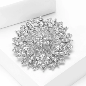 Detail view of crystal mandala brooch with intricate openwork and shiny rhinestones