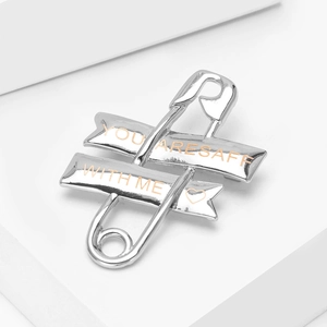 Silver safety pin brooch with engraved You Are Safe With Me ribbon and heart detail