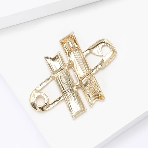 Detailed back view of gold safety pin brooch showing secure clasp and metal texture