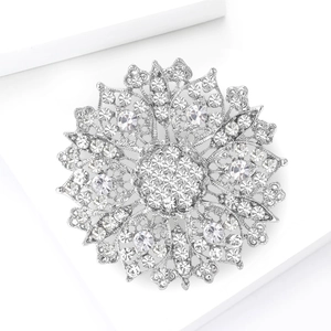 Macro shot of silver-plated hollow flower brooch with sparkling crystal rhinestones
