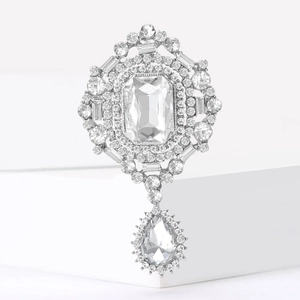 Vintage silver brooch featuring an emerald-cut glass stone and teardrop pendant