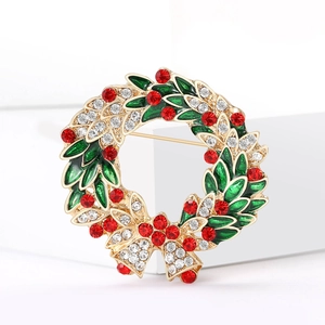Exquisite Christmas wreath brooch with green enamel leaves and red rhinestone accents