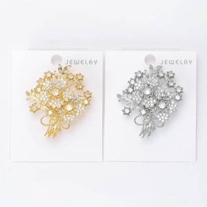 Detailed view of luxury bouquet brooches with sparkling zircon stones in gold and silver