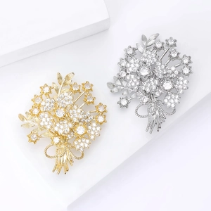 Elegant bouquet flower brooches with cubic zirconia and ribbon bow on white background