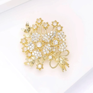 Detailed macro of golden bouquet brooch with sparkling zircon in a jewelry box