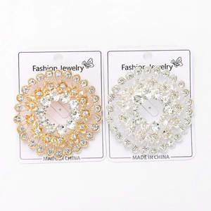 Detailed close-up of sparkling rhinestone circle brooches in gold and silver finishes