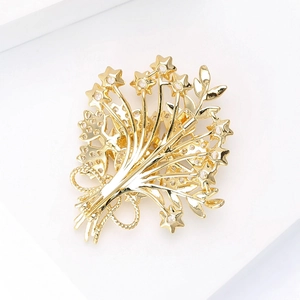 Elegant gold bouquet brooch with cubic zirconia stars on a minimalist white background