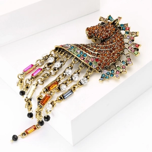 Macro detail of vintage horse head brooch with sparkling rhinestones and colorful tassels