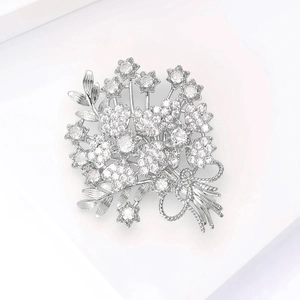 Close-up of luxury flower bouquet brooch with sparkling zircons and a silver bow detail