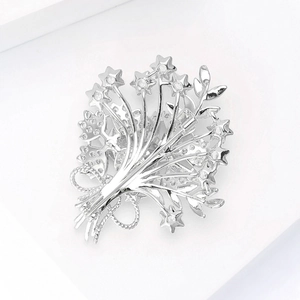Detailed view of silver bouquet brooch with cubic zirconia stars and polished finish