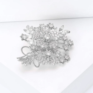 Close-up of sparkling zircon flower bouquet brooch with elegant ribbon bow detail