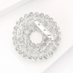 Detailed back view of silver rhinestone brooch showing the secure safety pin clasp