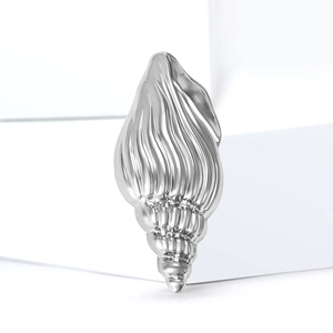 Minimalist silver conch brooch with polished metallic texture and spiral seashell design