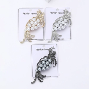 Detailed trio of feather brooches with pearls and rhinestones on display cards