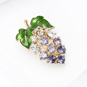 Detailed macro of crystal grape brooch with green enamel leaves and purple rhinestones