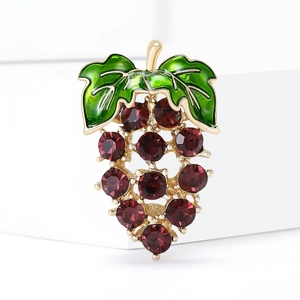 Elegant gold grape brooch with purple crystals and green enamel leaves on white background