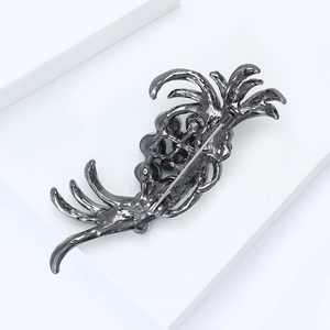 Detail view of gunmetal brooch back with elegant streamline design and metal pin buckle