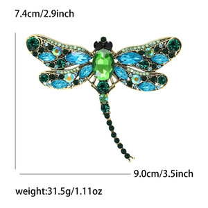 Detailed view of dragonfly brooch with blue rhinestones and product size specifications