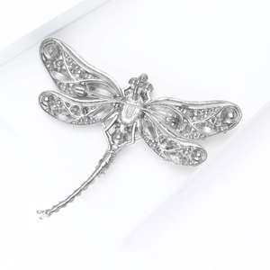 Detail view of the dragonfly brooch back showing the pin closure and cutout wing patterns