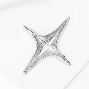 Silver four-pointed star brooch back view with honeycomb structure and pin clasp detail