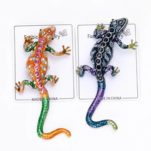 Detailed macro view of colorful enamel lizard brooches with sparkling rhinestone accents