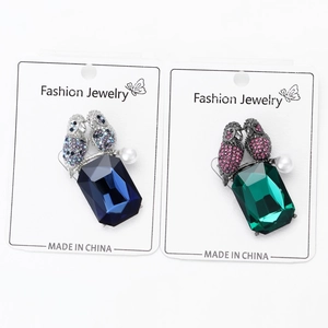 Detail of owl brooches with large rectangular crystals and small pavé diamonds and pearls