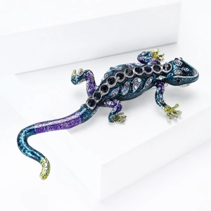 Macro detail of enamel lizard brooch with blue crystals and sparkling rhinestones